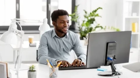 un homme optimise son profil Linkedin sur son ordinateur